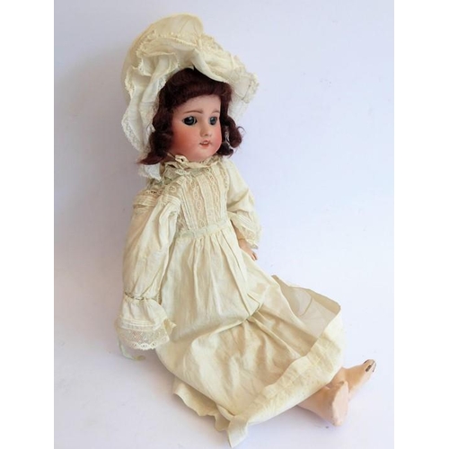 326 - An early 20th century bisque-headed doll in cream lacework gown and bonnet; composition body (damage... 