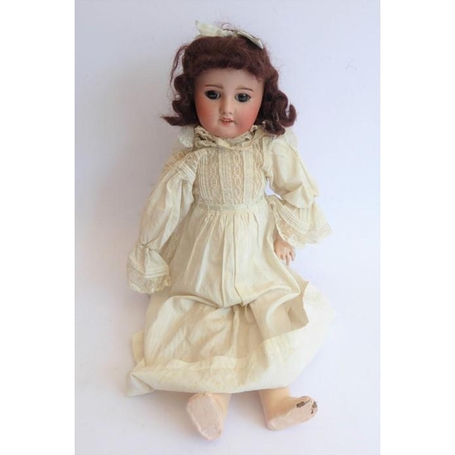 326 - An early 20th century bisque-headed doll in cream lacework gown and bonnet; composition body (damage... 