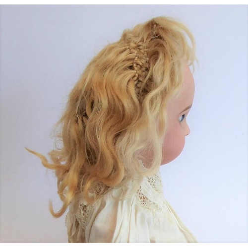 327 - A late 19th century bisque head doll; the back of the head stamped in red 'Tête Juméau'; curly blond... 