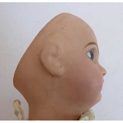 327 - A late 19th century bisque head doll; the back of the head stamped in red 'Tête Juméau'; curly blond... 