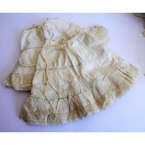 328 - A very good selection of early dolls clothing etc. to include lacework dresses, a pair of skirts, so... 