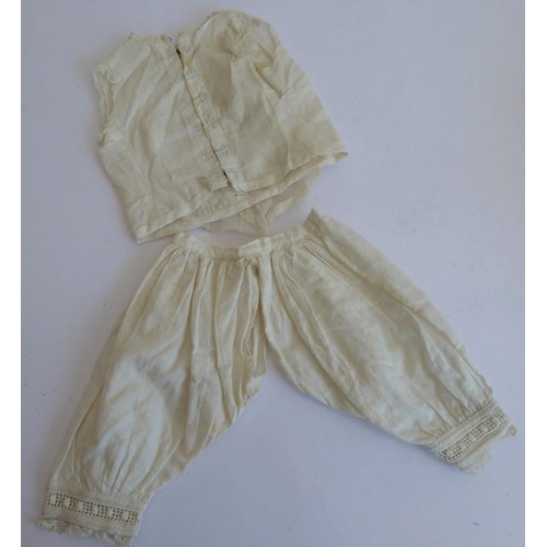 328 - A very good selection of early dolls clothing etc. to include lacework dresses, a pair of skirts, so... 