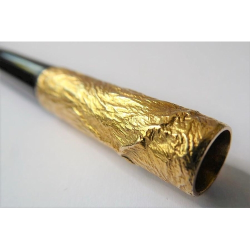 329 - A 9-carat topped cigarette holder by Dunhill, the detachable textured gold terminal with AD mark, Lo... 