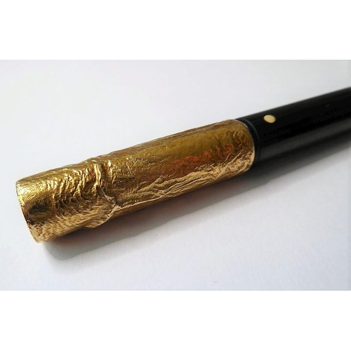 329 - A 9-carat topped cigarette holder by Dunhill, the detachable textured gold terminal with AD mark, Lo... 