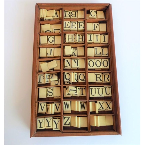 338 - A 19th century mahogany box containing bone tablets engraved with alphabet letters