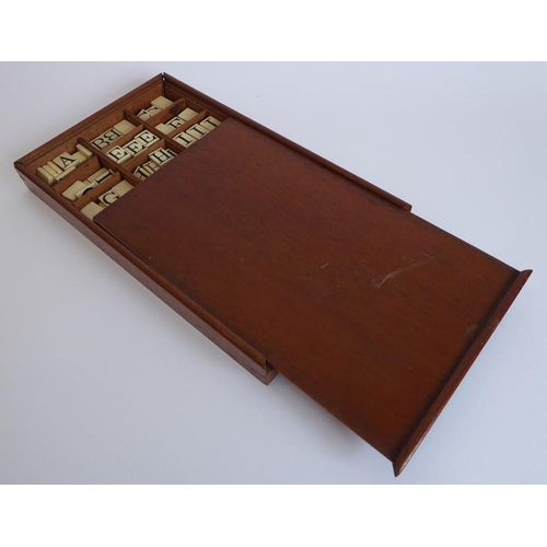 338 - A 19th century mahogany box containing bone tablets engraved with alphabet letters