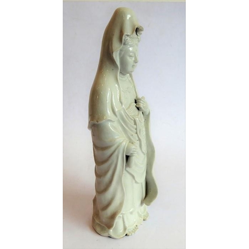 34 - A finely modelled Japanese blanc de chine ceramic model of the Japanese goddess Kannonsama; she wear... 