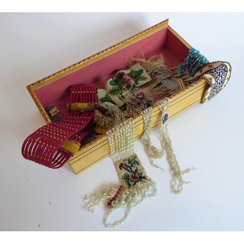 345 - A 19th century painted box with sliding lid containing an assortment of hand-made beadwork bracelets... 