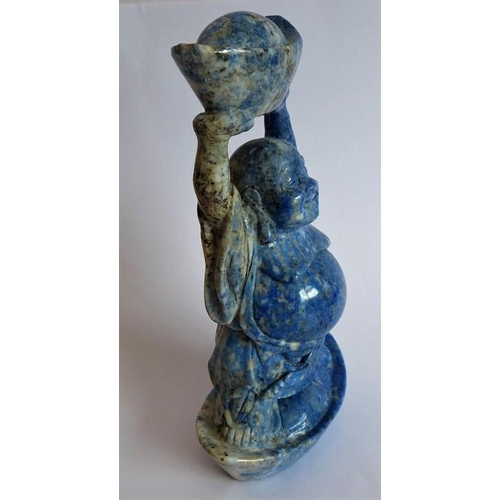 350 - A hand-carved lapis lazuli model of a Buddha standing in and also holding aloft large boat-shaped ob... 