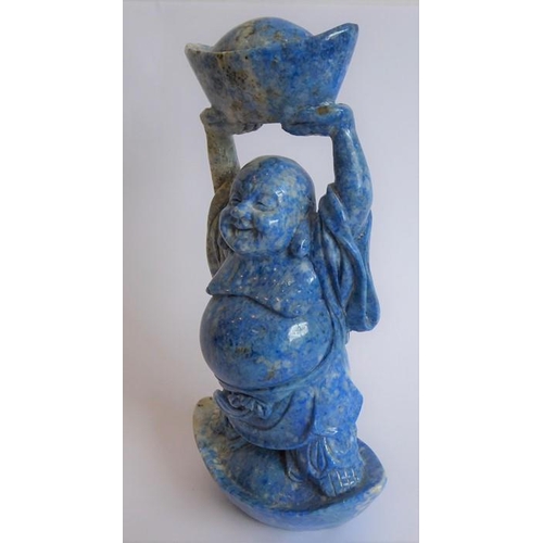 350 - A hand-carved lapis lazuli model of a Buddha standing in and also holding aloft large boat-shaped ob... 