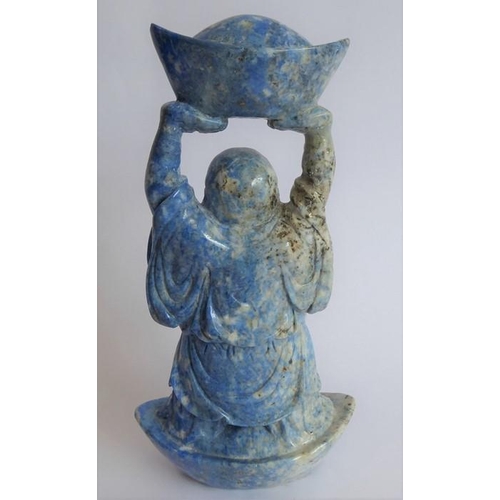 350 - A hand-carved lapis lazuli model of a Buddha standing in and also holding aloft large boat-shaped ob... 