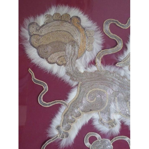 355 - A gilt framed and glazed animal fur and silver wire needlework depicting a Qilin upon a symbolic Bud... 