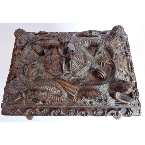 361 - A 19th century oak casket; heavily carved in relief with a marine theme, with a central cherubic fig... 