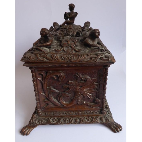 361 - A 19th century oak casket; heavily carved in relief with a marine theme, with a central cherubic fig... 