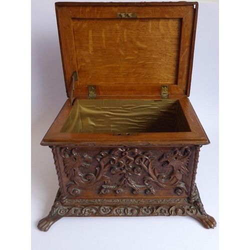 361 - A 19th century oak casket; heavily carved in relief with a marine theme, with a central cherubic fig... 