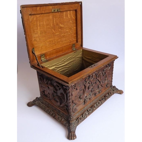 361 - A 19th century oak casket; heavily carved in relief with a marine theme, with a central cherubic fig... 