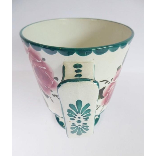 38 - An early 20th century two-handled Wemyss Pottery loving cup; hand-decorated with roses, stamped Wemy... 