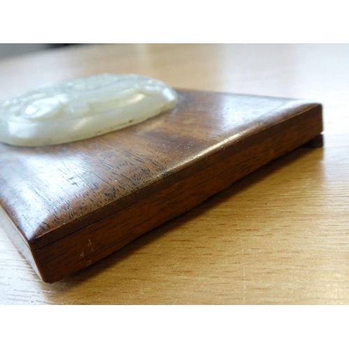 380 - A rectangular hardwood box and cover; the lid mounted with an oval carved Chinese celadon jade table... 