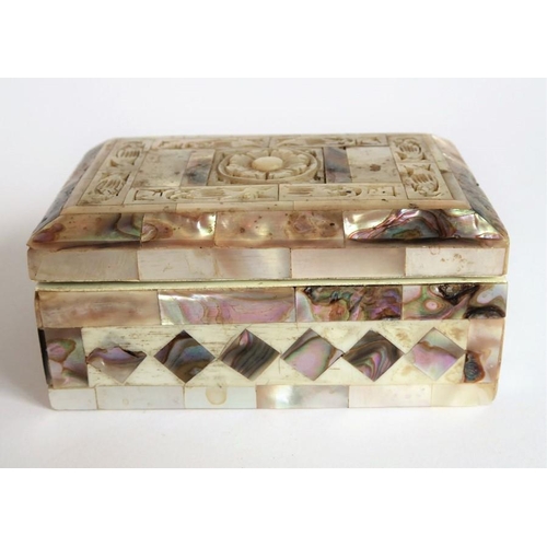 388 - An ornate mother of pearl inlaid box; the hinged lid opening to reveal a red lining (9.25cm wide)