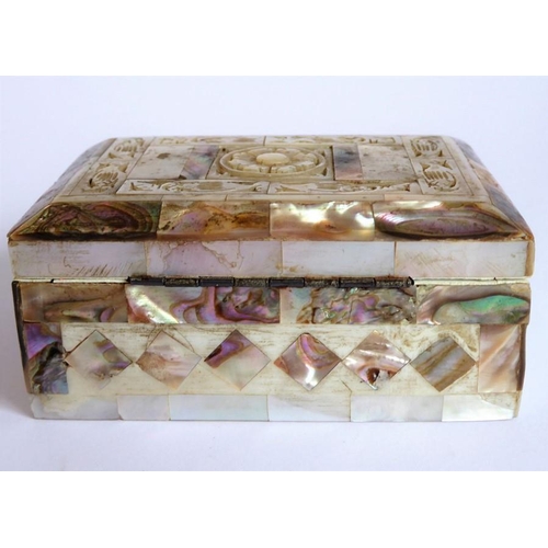 388 - An ornate mother of pearl inlaid box; the hinged lid opening to reveal a red lining (9.25cm wide)