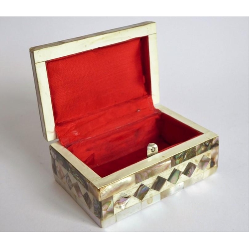 388 - An ornate mother of pearl inlaid box; the hinged lid opening to reveal a red lining (9.25cm wide)