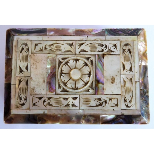 388 - An ornate mother of pearl inlaid box; the hinged lid opening to reveal a red lining (9.25cm wide)