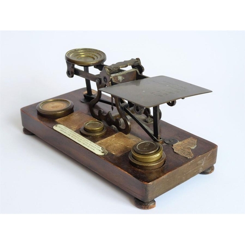 396 - A set of 19th century brass postal scales with weights and raised upon a mahogany plinth base (27cm ... 