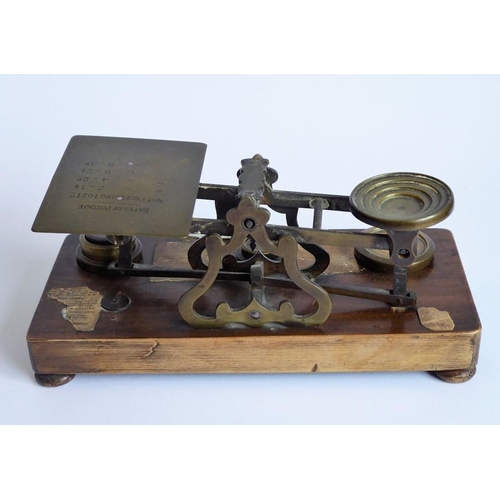 396 - A set of 19th century brass postal scales with weights and raised upon a mahogany plinth base (27cm ... 