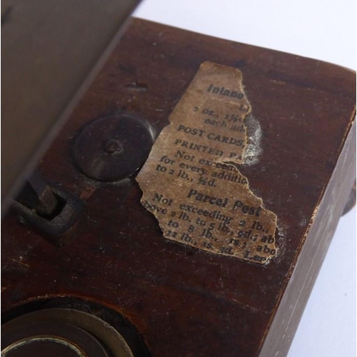 396 - A set of 19th century brass postal scales with weights and raised upon a mahogany plinth base (27cm ... 