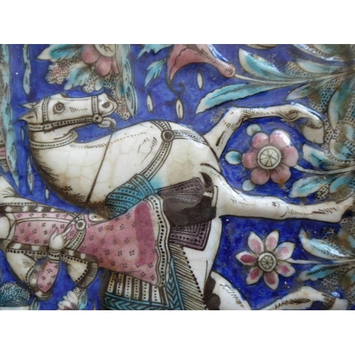 4 - Four early to mid-19th century hand-decorated Persian tiles; each depicting a mounted rider, his lef... 