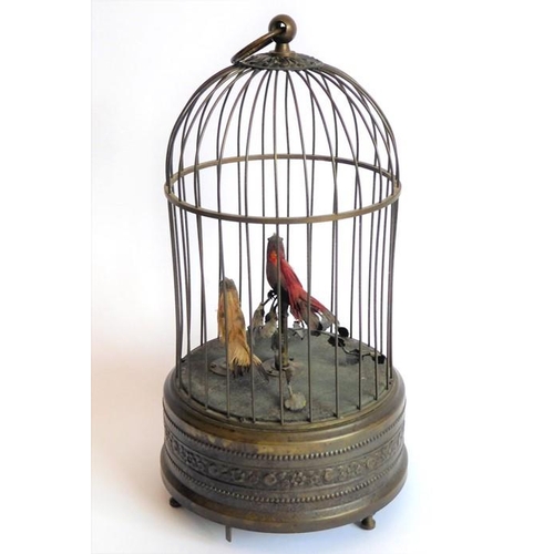 407 - An early 20th century brass-cased, dome-topped singing birdcage automaton; the round suspension loop... 