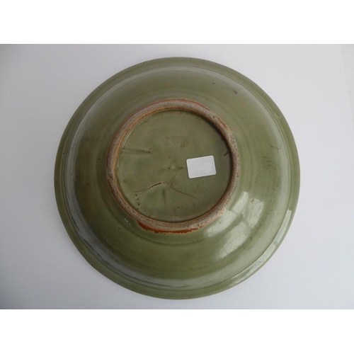 42 - A large early 17th century Chinese Longquan bowl with celadon glaze; the moulded lip above a central... 