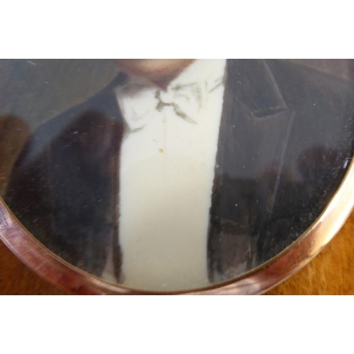 423 - An early 20th century oval shoulder-length portrait miniature; rose-gold-coloured oval frame, the ge... 