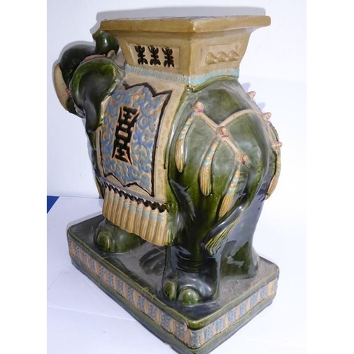 44 - A large Chinese stoneware jardinière stand modelled as a trumpeting elephant; the central howdah res... 