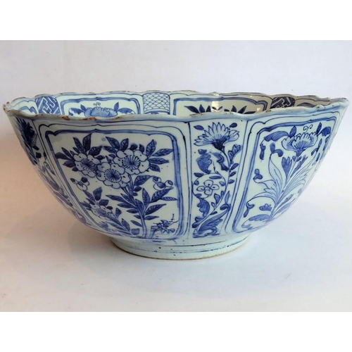 50 - A large 17th century Chinese porcelain bowl hand decorated in underglaze blue and white with Buddhis... 