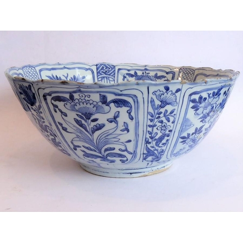 50 - A large 17th century Chinese porcelain bowl hand decorated in underglaze blue and white with Buddhis... 