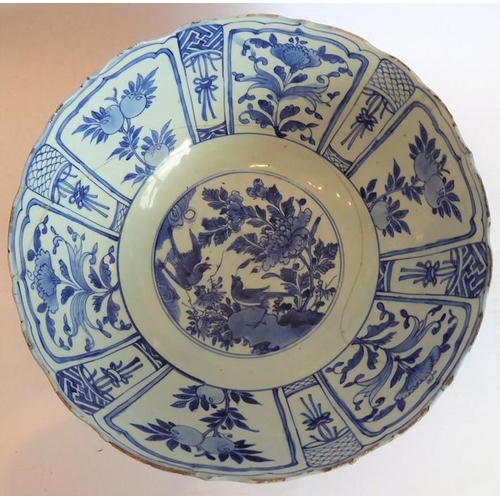 50 - A large 17th century Chinese porcelain bowl hand decorated in underglaze blue and white with Buddhis... 