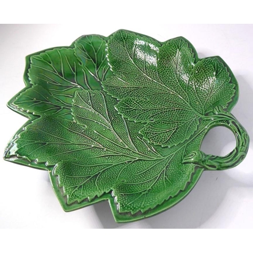 53 - A set of four finely moulded green leaf ceramic dishes, together with one other similar example with... 