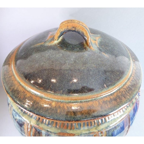 57 - Jane O' Clark studio pottery; a barrel-shaped lidded food container, the lid with loop handle above ... 