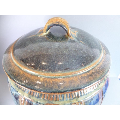 57 - Jane O' Clark studio pottery; a barrel-shaped lidded food container, the lid with loop handle above ... 