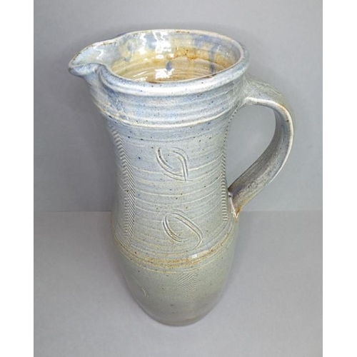 61 - Ray Finch (British, 1914-2012) studio pottery - a reglazed jug with applied handle and incised decor... 