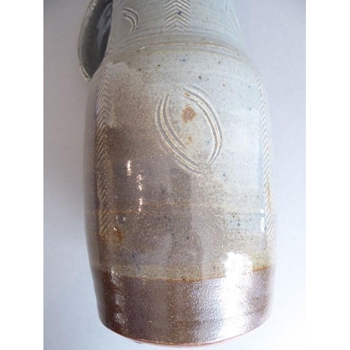 61 - Ray Finch (British, 1914-2012) studio pottery - a reglazed jug with applied handle and incised decor... 