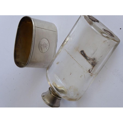 64 - A 19th century transparent glass and silver-mounted hip flask; both the engine-turned screw-top and ... 