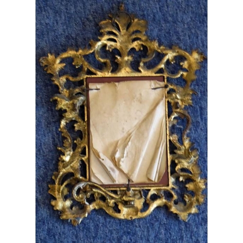 654 - A 19th century looking glass; the cast gilt-metal frame in 18th century Florentine style, wall hangi... 