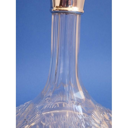 69 - A finely cut crystal ship's decanter with silver-mounted collar; the heavy spherical crystal stopper... 