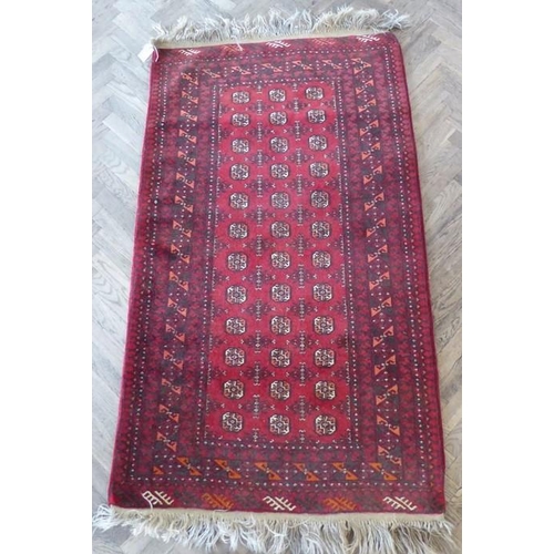 711 - A red ground Afghan carpet with gul pattern (north Afghanistan) (178cm x 106cm)