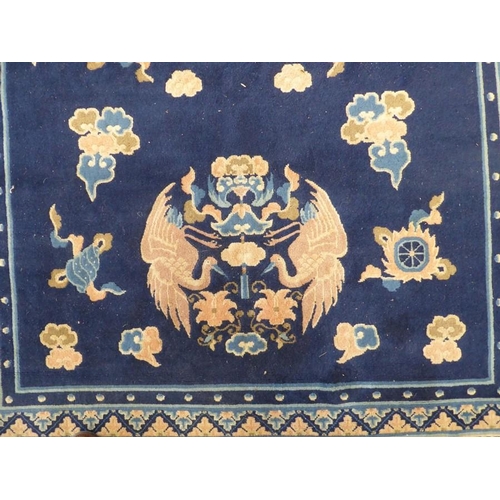 712 - A mid-20th century Chinese blue ground Peking carpet decorated with Fen etc. (245cm x 155cm)