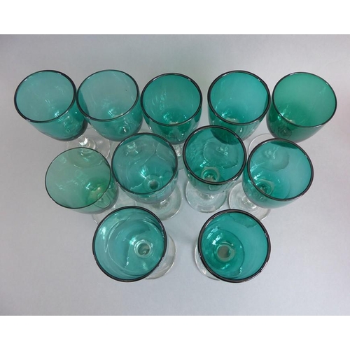 72 - Eleven 19th century green glass wines, together with five cranberry glass-style tapering beakers and... 