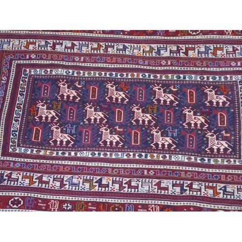 721 - An Easter Tribal wall hanging central rectangular blue ground medallion depicting various stylised a... 