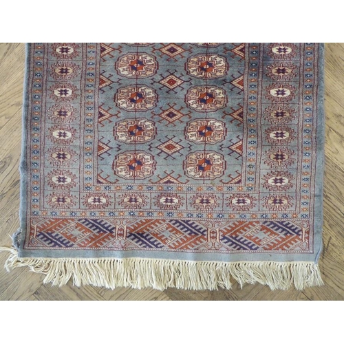 730 - A light-blue ground Pakistan runner with gul pattern (480cm x 79cm)